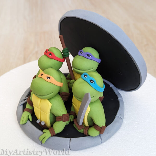 Ninja Turtles coming out of Sewer cake topper