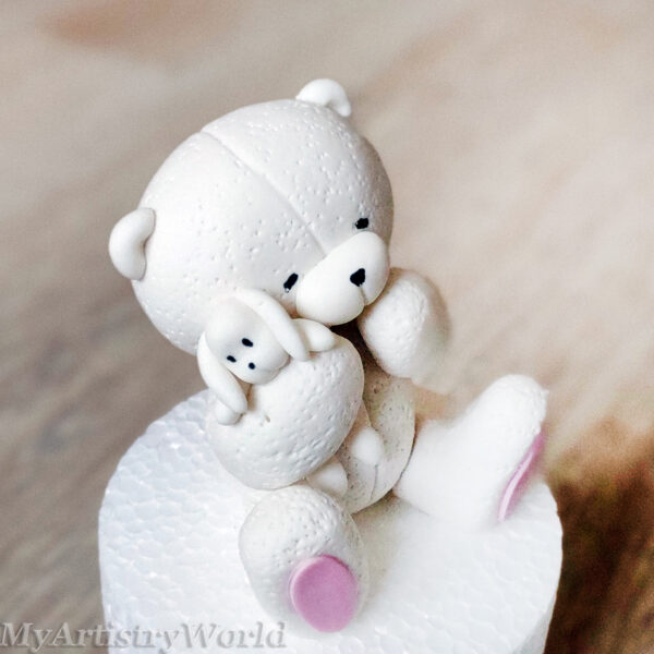 Bear holding a toy bunny cake topper