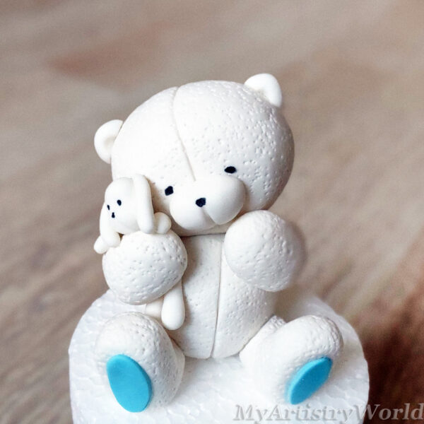 Bear holding a toy bunny cake topper