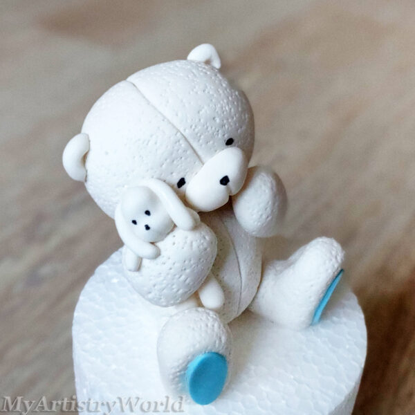 Bear holding a toy bunny cake topper