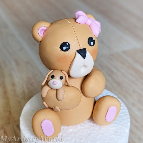 Bear holding a toy bunny cake topper