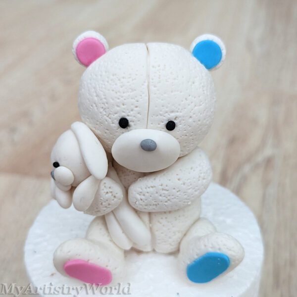 Bear holding a toy bunny cake topper